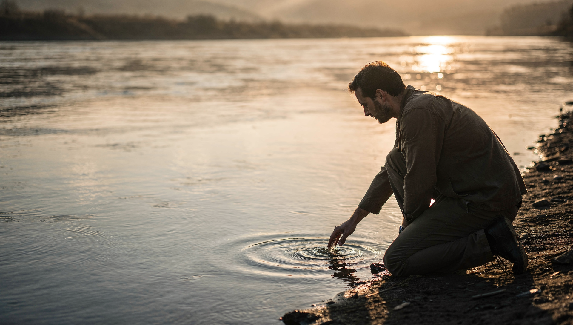 Figure reading the river